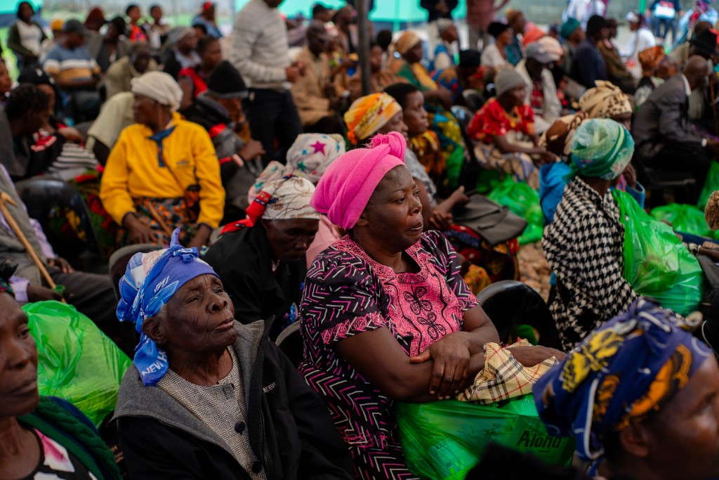 Elderly community members with their Christmas hamper bags