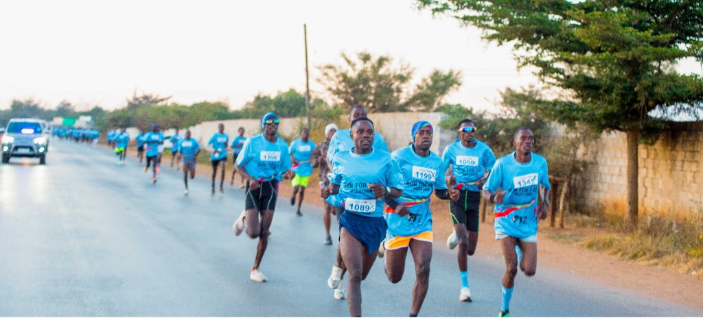 Runners in blue shirts taking part in the Run for Life community marathon